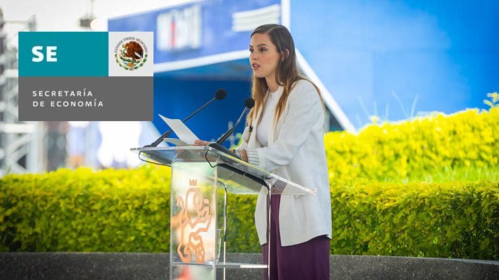 Woman Delivering a Speech at an Outdoor Podium with a Government Logo Visible on the Left and a Blue Background Behind Her. › La Sierra Madre