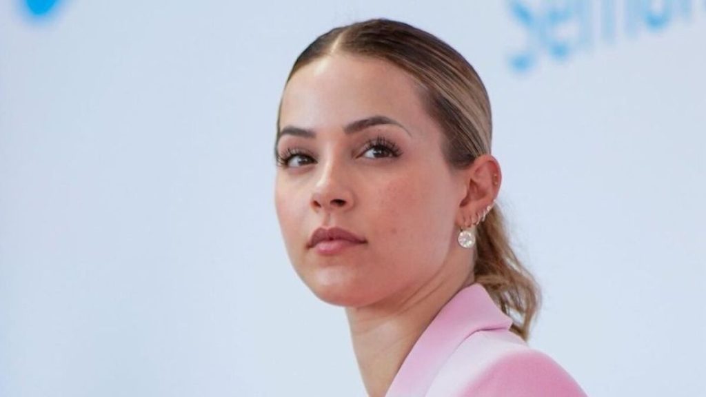 Portrait of a Woman with Light Pink Blazer Looking to the Left, Wearing Pearl Earrings Against a Pale Blue Background › La Sierra Madre