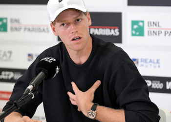 Male Tennis Player Wearing a White Cap at a Press Conference, Hand on His Chest, Speaking into a Microphone. › La Sierra Madre