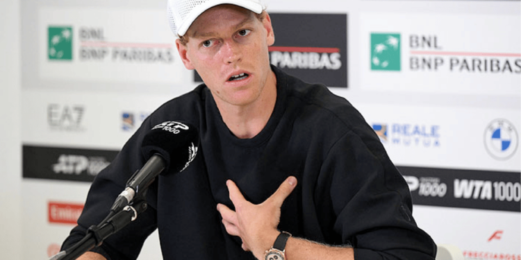 Male Tennis Player Wearing a White Cap at a Press Conference, Hand on His Chest, Speaking into a Microphone. › La Sierra Madre
