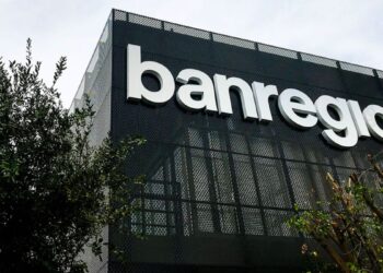 Modern Bank Building with Large White 'banregio' Letters on a Dark Perforated Facade, Greenery in the Foreground. › La Sierra Madre