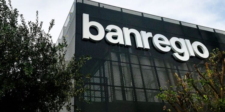 Bloque 2- Junio 16 › La Sierra Madre Modern Bank Building with Large White 'banregio' Letters on a Dark Perforated Facade, Greenery in the Foreground. › La Sierra Madre