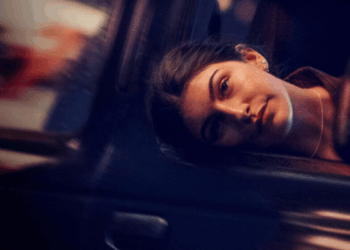 Woman with Dark Hair Resting Her Head Against a Car Window in a Dimly Lit Night Scene. › La Sierra Madre