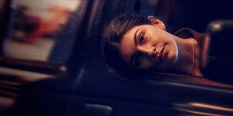 Woman with Dark Hair Resting Her Head Against a Car Window in a Dimly Lit Night Scene. › La Sierra Madre