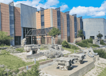 Modern Campus Building with Tan and Gray Facade, Glass Entry, and Outdoor Stone Sculptures in a Landscaped Plaza Under a Blue Sky › La Sierra Madre
