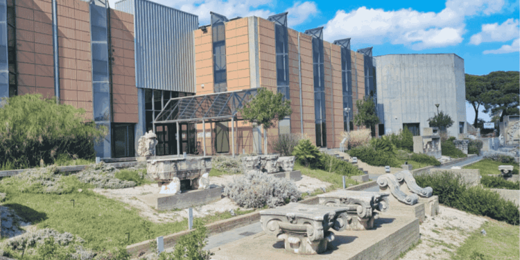 Robo De Pinturas Renacentistas En Italia › La Sierra Madre Modern Campus Building with Tan and Gray Facade, Glass Entry, and Outdoor Stone Sculptures in a Landscaped Plaza Under a Blue Sky › La Sierra Madre